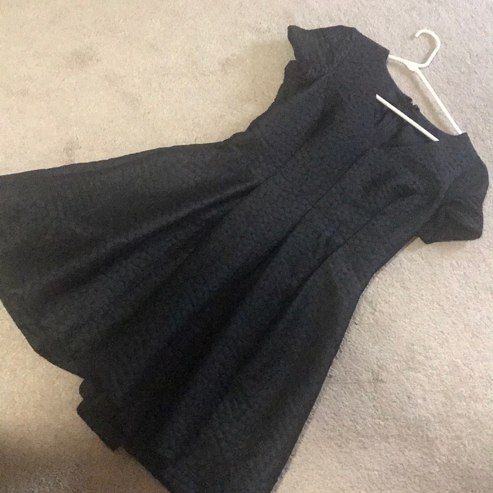 Black dress, pockets, zipper. Circled detail.